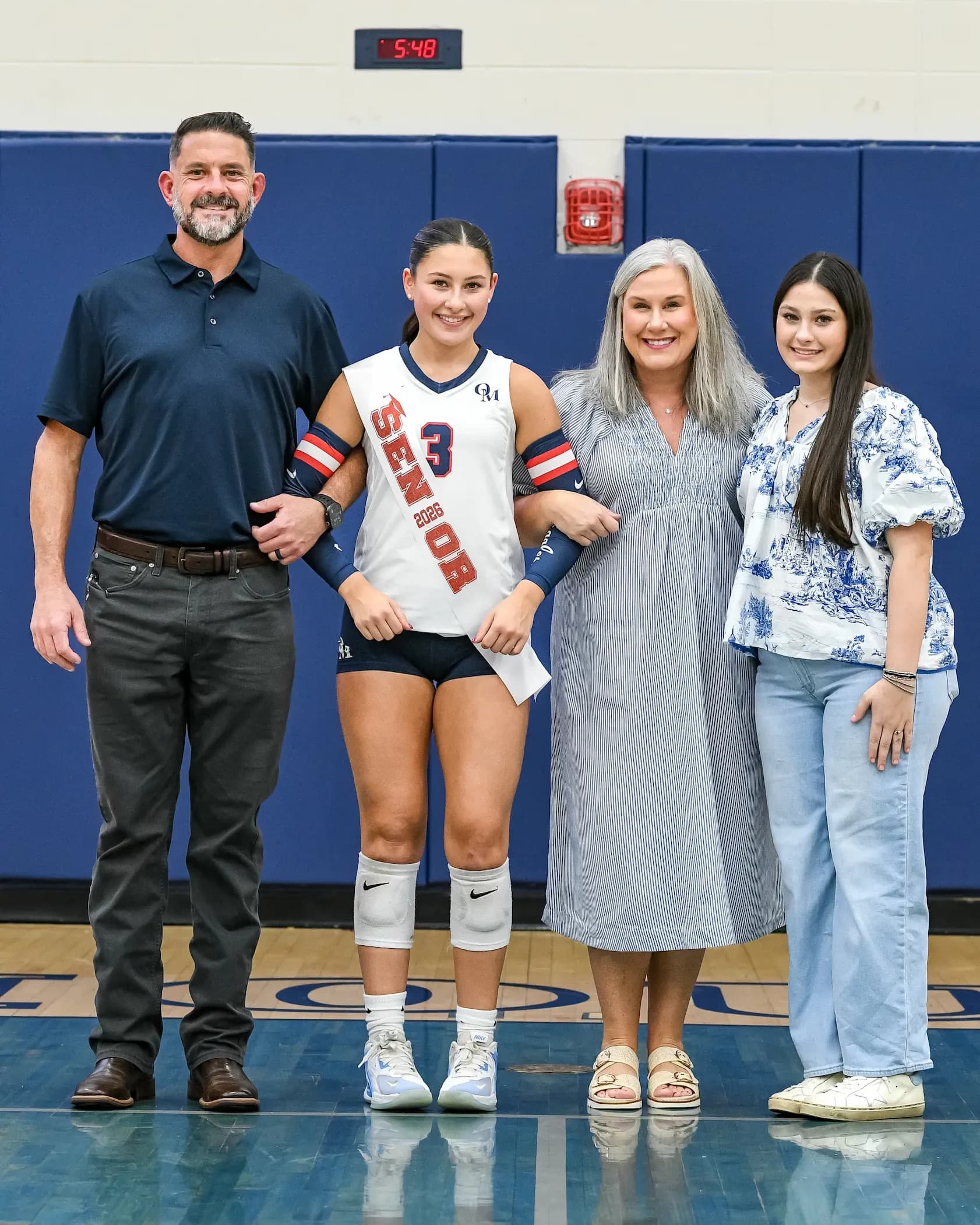 Kenny and Lori Gordon with their daughters at an Oak Mountain senior night, in the Oak Mountain gym