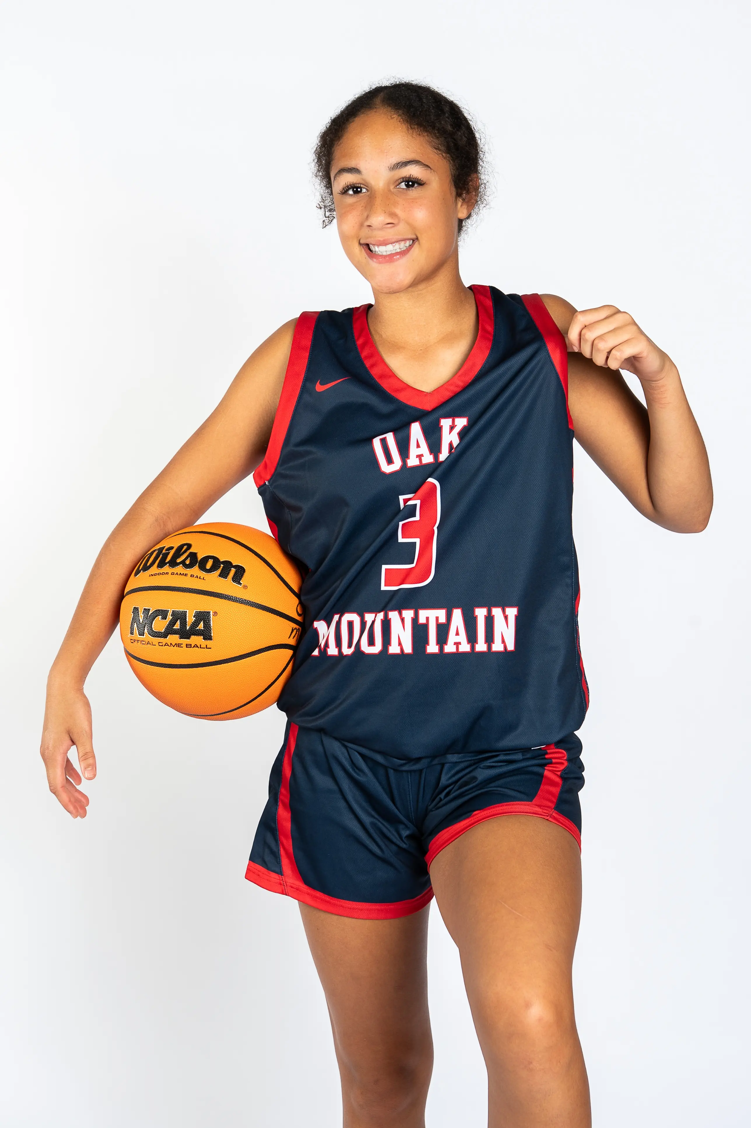 Oak Mountain basketball player with a ball, studio portrait