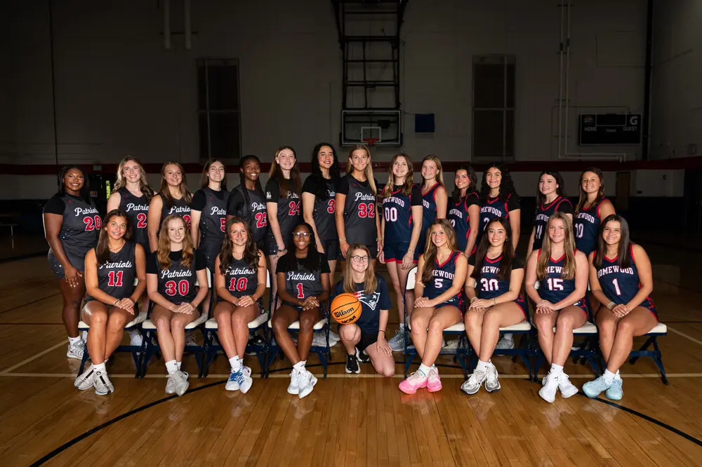 A full high-school volleyball team photographed in the gym